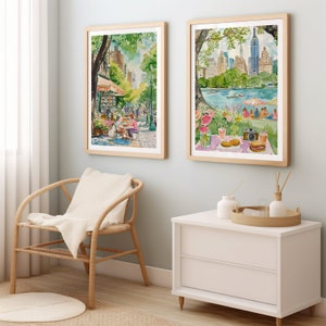 May include: Two framed watercolor paintings depicting scenes in New York City. The first painting shows a street scene with a cafe and people sitting outside. The second painting shows a view of Central Park with a picnic scene in the foreground.