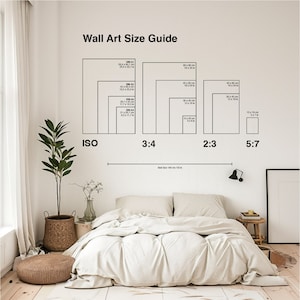 a white bed sitting under a window next to a white wall