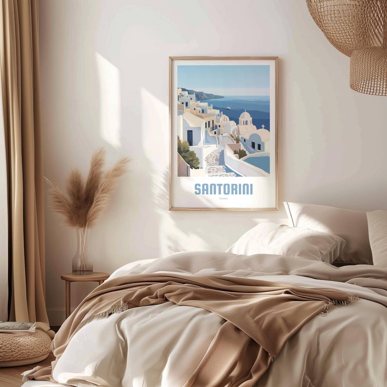 May include: A poster with a blue and white illustration of a town in Santorini, Greece. The poster has a white background with the word "SANTORINI" in blue text at the bottom.