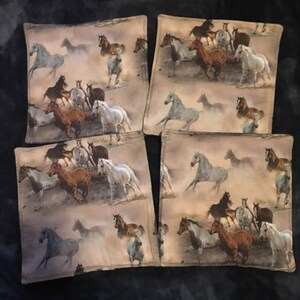 May include: Set of four beige coasters with a brown, white, and black horse design. The horses are running in a field with a blurred background.