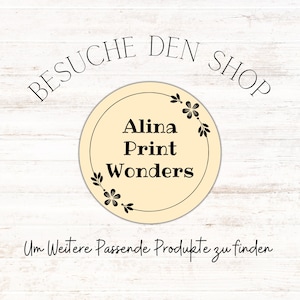 May include: A beige circle with a black floral border and the text "Alina Print Wonders" inside. The text "Besuche den Shop" is above the circle and the text "Um Weitere Passende Produkte zu finden" is below the circle.