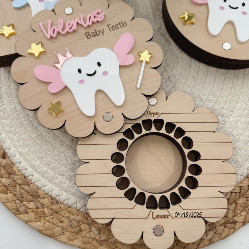 May include: A wooden baby tooth keepsake box with a fairy tooth design. The box has a slot for each tooth and is personalized with the name "Valeria" and the date "04/15/2025".