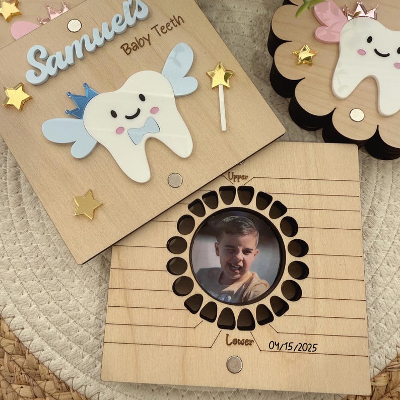 May include: A wooden tooth keepsake box with a blue and white tooth fairy design. The box has a compartment for storing baby teeth and a photo frame with a child's photo. The box is personalized with the name "Samuel" and the date "04/15/2025".