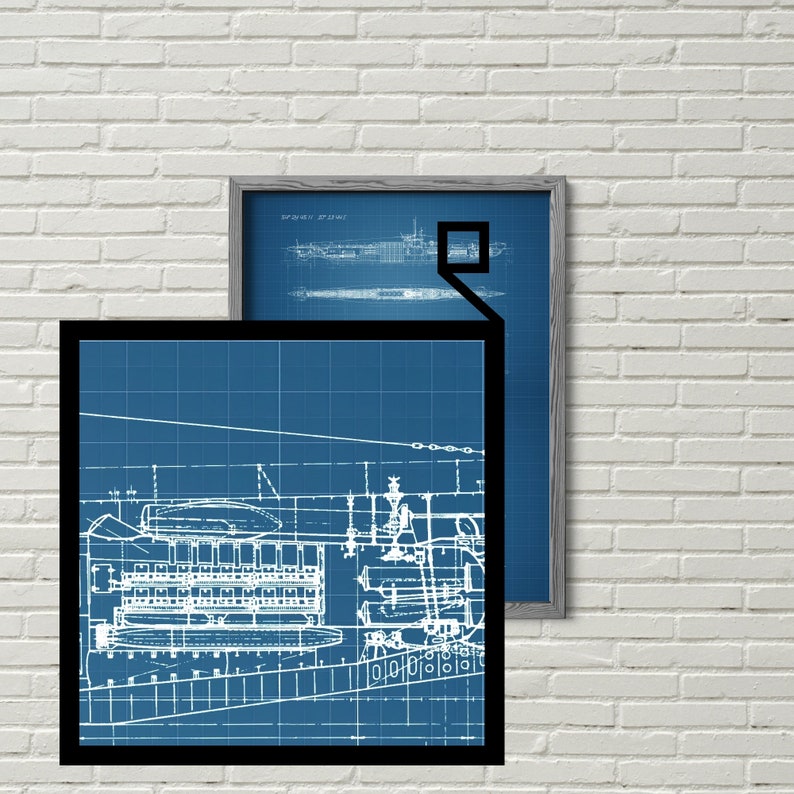 May include: A blueprint style illustration of a submarine, with a grid pattern and white lines on a blue background. The image is framed in black and is hanging on a white brick wall.