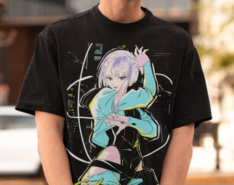 May include: Black t-shirt with a vibrant anime-style graphic and the text "Cyberpunk Edgerunners." The design depicts a female character in a futuristic setting. The shirt is worn by a person wearing a black cap and sunglasses.