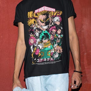 May include: Black t-shirt with a graphic print of characters from the anime My Hero Academia. The text "My Hero Academia" and Japanese characters are printed on the shirt.