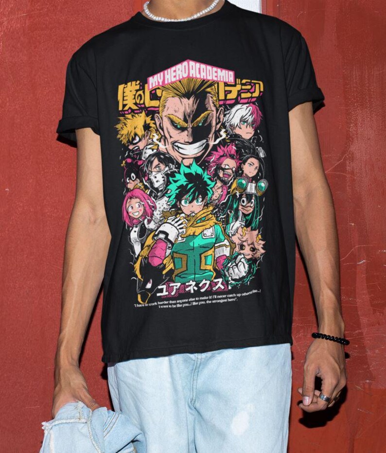 May include: Black t-shirt with a graphic print of characters from the anime My Hero Academia. The text "My Hero Academia" and Japanese characters are printed on the shirt.