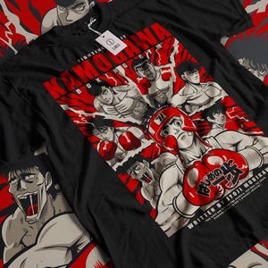 May include: Black t-shirt with a graphic of a group of boxers from the manga series "Hajime no Ippo". The graphic features the text "Kamogawa Boxing Gym" and "Fighting Spirit".