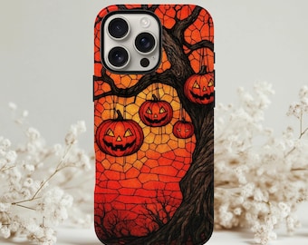 May include: A phone case featuring a Halloween-themed design. The case displays a tree with carved jack-o'-lanterns hanging from its branches against a stained-glass style orange and red background. The tree's trunk and branches are dark brown.