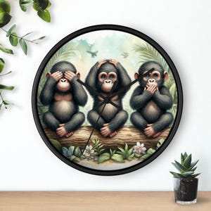 May include: A round wall clock with a black frame featuring three chimpanzees in the 'See no evil, hear no evil, speak no evil' pose. The chimpanzees are sitting on a log with a background of tropical foliage.