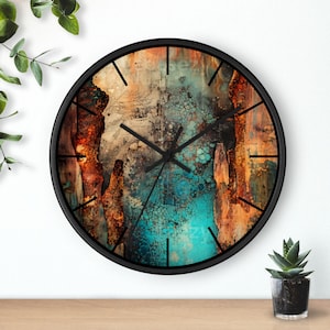 May include: Circular wall clock with a black frame and an abstract design in teal, orange, and brown. The clock has black hands and hour markers. This decorative clock would suit any room. The clock measures approximately 30 cm in diameter.