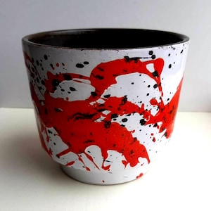 Può includere: Un set di tre tazze in ceramica con finitura opaca e macchiettata. Le tazze sono nei toni del crema, grigio chiaro e grigio scuro. Ogni tazza ha un design semplice e moderno, perfetto per caffè o tè.