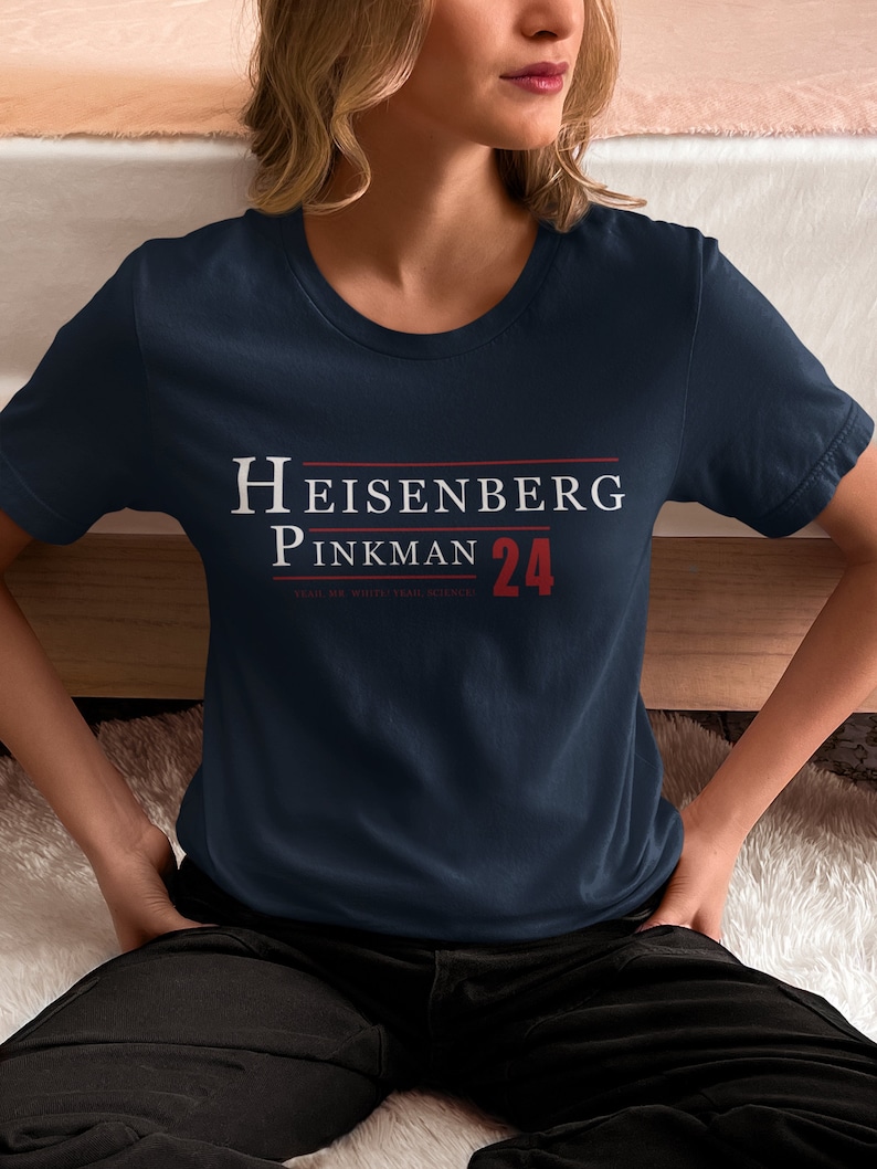 May include: A navy blue t-shirt with white text that reads "Heisenberg Pinkman 24" and the smaller text "Stay.  My.  White.  Trash.  Science."