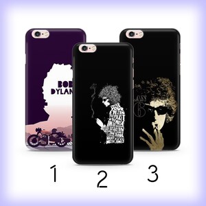 May include: Three phone cases with Bob Dylan designs. One case is purple with a silhouette and the text "BOB DYLAN". The second case is black with a white graphic and text. The third case is black with a sepia-toned image of Bob Dylan.
