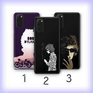 May include: Three different phone cases featuring Bob Dylan. The first case has a purple background with a silhouette of Bob Dylan and a motorcycle. The second case has a black background with a black and white image of Bob Dylan. The third case has a black background with a color image of Bob Dylan.
