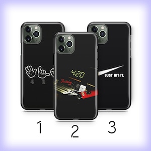 May include: Three black iPhone cases with different designs. The first case has a white outline of two hands making the '420' hand gesture. The second case has a black and red image of a lighter and a clock that reads '4:20'. The third case has a white swoosh design with the text 'JUST HIT IT.'
