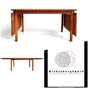 May include: A mid-century modern wooden dining table with a light brown woven top and fold-out leaves. The table is made of solid wood and has a rectangular shape. The table is approximately 60 inches long when closed.