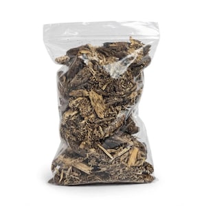 May include: A clear plastic resealable bag filled with dark brown wood chips and bark fragments. The contents consist of various sizes of organic woody material, ranging from small splinters to larger, textured pieces of tree bark.