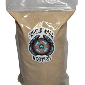 May include: A clear plastic resealable pouch filled with a fine, light tan granular substance. A circular sticker on the front features the text Shield Wald Exotics and an illustration of a brown shield decorated with small blue insect-like creatures.