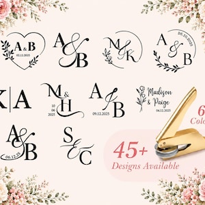 May include: A gold metal embosser tool displayed alongside various black ink monogram designs featuring initials, dates, and floral accents. The text 45+ Designs Available and 6 Colors is visible, surrounded by decorative floral corner illustrations.
