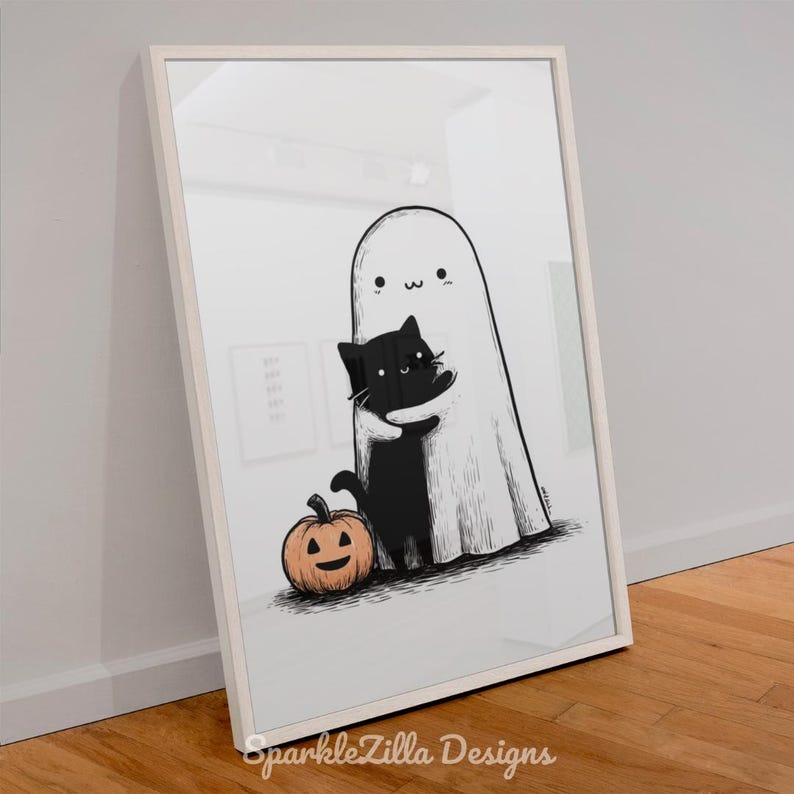 Cute black cat and ghost Halloween wall art leaning against wall.