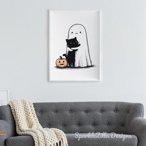Cute ghost hugging cat printable Halloween wall art above sofa.