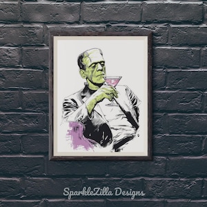 Classic Universal monster Lon Chaney Frankenstein sipping a martini wall art printable displayed in black frame on dark brick wall, retro Halloween bar cart decor.