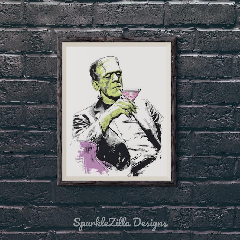 Classic Universal monster Lon Chaney Frankenstein sipping a martini wall art printable displayed in black frame on dark brick wall, retro Halloween bar cart decor.