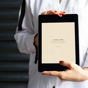 May include: A black tablet displaying a cream-colored screen with the text "Metaphysics of Mind" centered in a dark serif font. The screen also includes smaller sub-text below the title, presenting a clean, digital interface for reading.