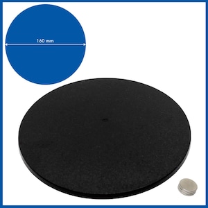 May include: A black, round turntable with a diameter of 160 mm. The turntable is made of a smooth, black material and has a small hole in the center. The turntable is sitting on a white surface. There are two small, round magnets next to the turntable.