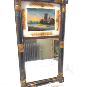 May include: A white ceramic mug with a black handle and the text "But First, Coffee" in a black, handwritten-style font. The mug is on a white surface.