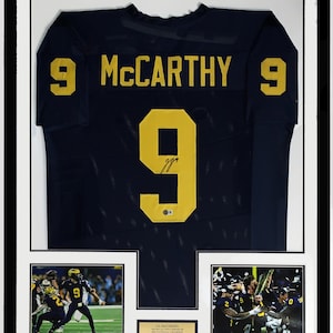J.J. McCarthy Authentic Signed 2023 Michigan Wolverines Jersey & National Championship Photo - Beckett Authenticated COA - Framed and Plate