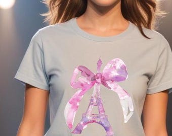 May include: A light blue t-shirt with a pink watercolor design of the Eiffel Tower with a bow on top.