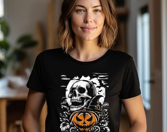 May include: Black t-shirt featuring a Halloween design. The graphic includes a skull, a jack-o'-lantern, a witch's hat, and the word "HALLOWEEN" in white. The design is set against a backdrop of a full moon and bats.