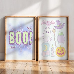 May include: Two framed Halloween art prints. One shows the word "BOO!" in green dripping letters, with bats. The other print displays a ghost, bat, witch hat, cauldron, broom, pumpkin, candle, and tarot card.
