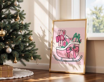 May include: A framed Christmas print featuring a pink sleigh filled with gifts and the words "HO HO HO." The sleigh has a large pink bow and is set against a pink striped background. A Christmas tree is in the background.
