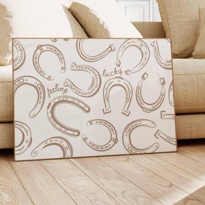 brown and white horseshoes print with feeling lucky quote in hand drawn script font, horizontal wall art