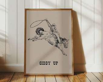 May include: A black and white line drawing of a cowboy riding a bucking horse. The cowboy is holding a lasso in his right hand. The image has the text "Giddy Up" below the drawing.