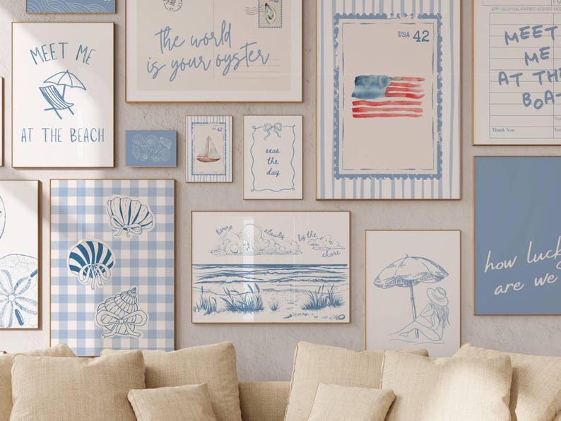 May include: A collection of framed art prints with a beach theme. The prints feature illustrations of seashells, beach scenes, and text like "Meet Me at the Beach" and "The world is your oyster." The color palette is primarily blue and white.