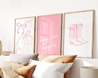 May include: Three pink framed prints with white text and illustrations. The left print features pink bows. The middle print says "long live cowgirls". The right print shows a pair of pink cowboy boots.