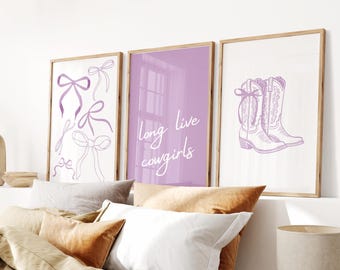 May include: Three framed prints with a purple and white color scheme. The left print features a series of bows. The center print has the text "long live cowgirls" in white. The right print shows a pair of cowboy boots.