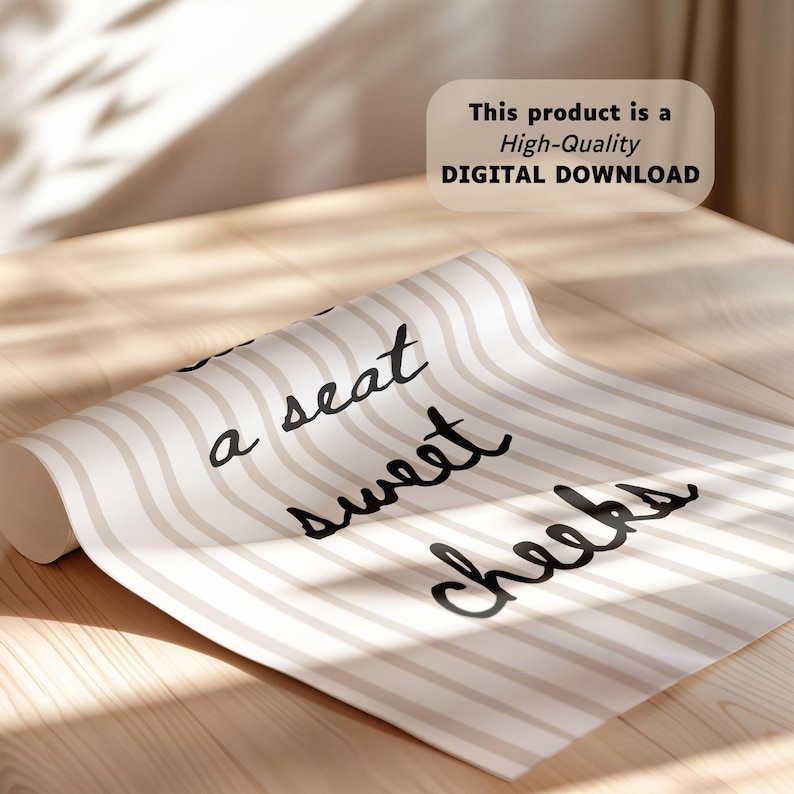 May include: Rolled-up beige and white striped paper with the text "a seat sweet cheeks" in black cursive. The paper is on a light wooden surface. A digital download product.