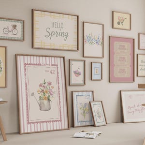 May include: A collection of framed art prints with a spring theme. The prints feature floral designs, bicycles, and the words "Hello Spring." The color palette includes soft pinks, greens, and yellows, creating a cheerful and inviting atmosphere.