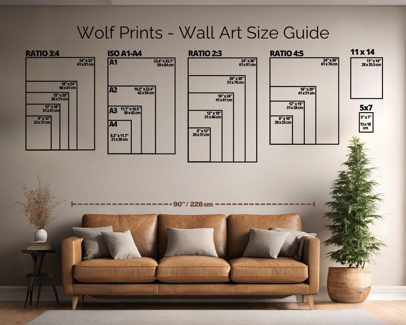 May include: A wall art size guide from Wolf Prints, featuring various aspect ratios and sizes, including 11 x 14 inches and 5 x 7 inches. The guide is displayed above a brown leather sofa, with a small potted tree to the right. The text reads "Wolf Prints - Wall Art Size Guide".