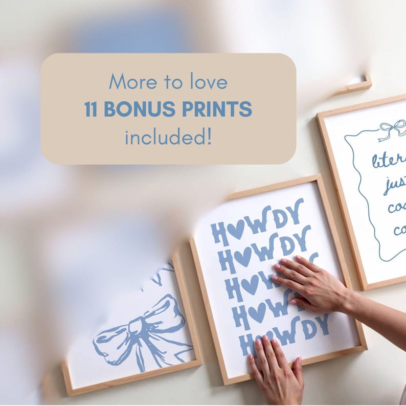 May include: Several framed art prints with light wood frames are displayed on a white wall. One print says "HOWDY" in blue letters with blue hearts. Another print has a bow design. The text "More to love 11 BONUS PRINTS included!" is also visible.