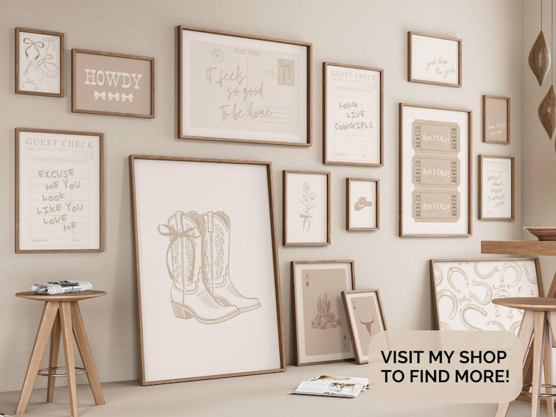 May include: A display of framed wall art with a rustic, country theme. The art features prints with text such as "HOWDY" and "It feels so good to be home," alongside drawings of cowboy boots and other Western motifs. The colour palette is neutral, with beige and brown tones.
