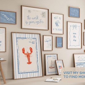 May include: A collection of framed art prints with a coastal theme. The prints feature nautical illustrations, including a lobster, sailboat, and beach scenes. The color palette includes blue, white, and brown tones. Some prints have text like "Meet Me at the Beach."