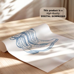 May include: A white sheet of paper featuring a blue line art illustration of a pair of cowboy boots with decorative stitching. The text "This product is a High-Quality DIGITAL DOWNLOAD" is printed in black in the upper right corner of the image.