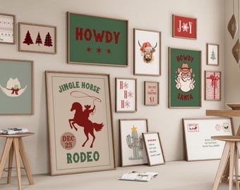 May include: A gallery wall with a western Christmas theme. The prints feature a cowboy hat, a jingle horse rodeo poster, a cactus, a bull wearing a Santa hat, and various Christmas greetings. The prints are framed in wood and arranged in a grid pattern on a white wall.
