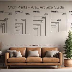 May include: A wall art size guide from Wolf Prints, showing different aspect ratios and sizes, including 28 x 35.5 cm and 13 x 18 cm. The guide is displayed above a brown leather sofa, with a small potted tree to the right. The text reads "Wolf Prints - Wall Art Size Guide".